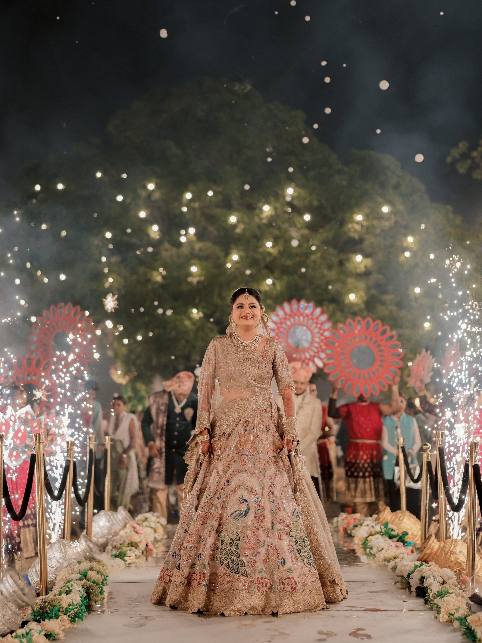 A bride making her entrance beneath sparkling lights
